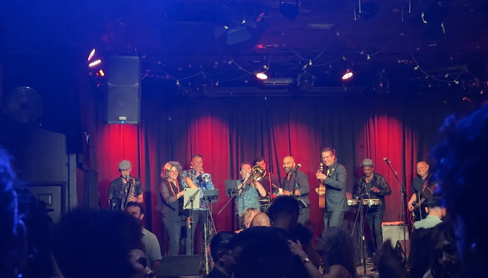 Guajirón's full orchestra performing as couples dance at La Peña Cultural Center